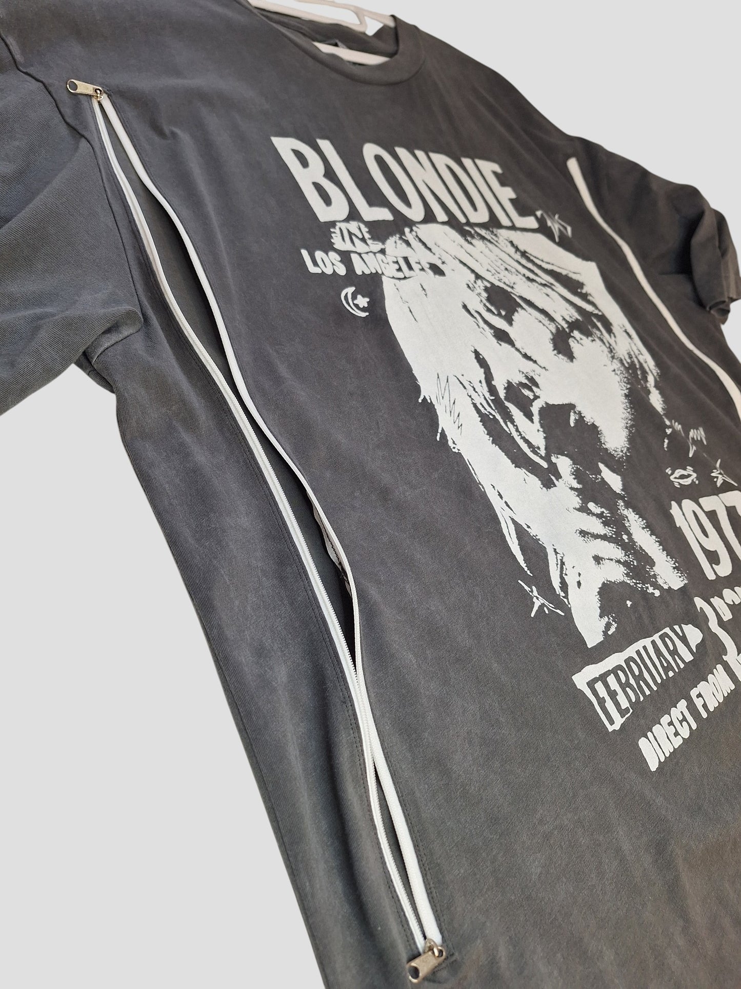 The Nutmeg Upcycled Breastfeeding & Pumping Grey Blondie Band T-shirt UK20 (100361) features white graphics, stylish side zipper for easy nursing access, and is an ideal upcycled choice for breastfeeding moms.