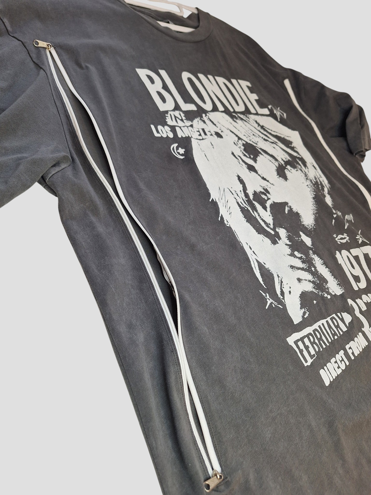 The Nutmeg Upcycled Breastfeeding & Pumping Grey Blondie Band T-shirt UK20 (100361) features white graphics, stylish side zipper for easy nursing access, and is an ideal upcycled choice for breastfeeding moms.