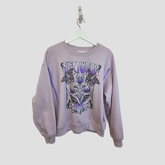 This upcycled H&M lilac sweatshirt (size M) for breastfeeding and pumping features a bold abstract floral and butterfly Fleetwood Mac graphic—an eco-friendly twist on classic band merch.