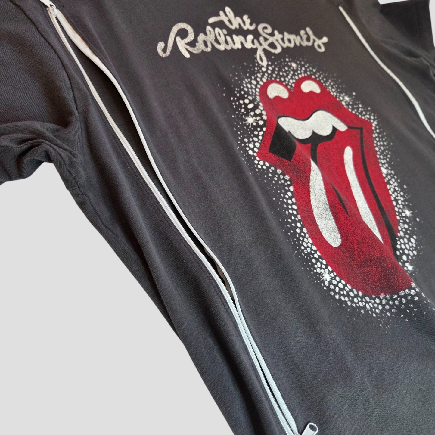 An H&M Upcycled Rolling Stones Band T-shirt (size L) for breastfeeding and pumping, in grey/red with white stars and iconic tongue logo, displayed on a light gray background.