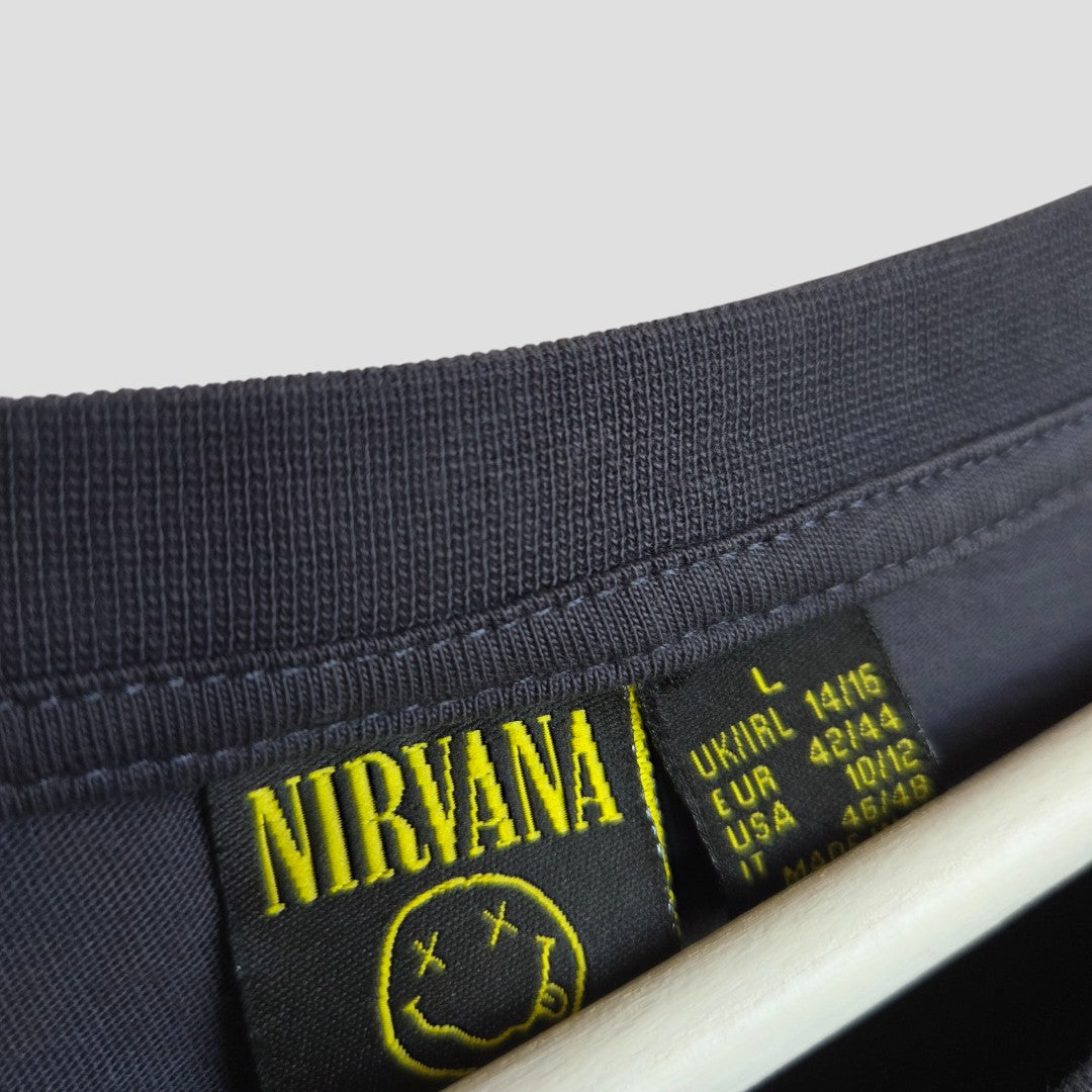 Close-up of a Primark Upcycled Breastfeeding & Pumping Nirvana Band T-shirt (Grey/Yellow, L/UK14-16), featuring a yellow smiley tag on the collar—an eco-friendly nursing option made from pre-loved clothing.