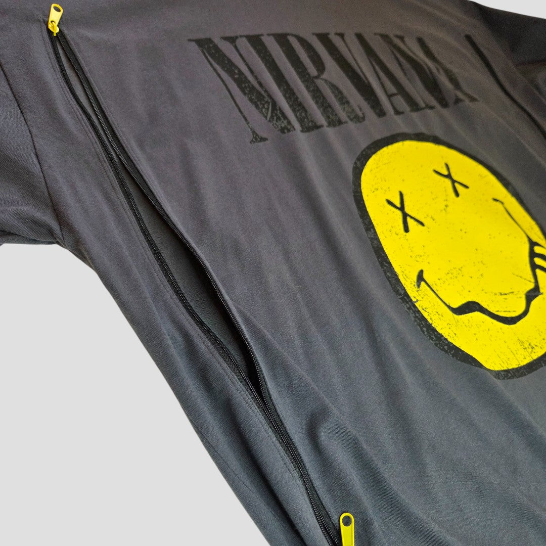 A preloved Primark Nirvana band t-shirt in grey with black zippers and a yellow smiley face graphic, size L (UK14/16), upcycled for breastfeeding and pumping. Photo shows item against a plain light background.