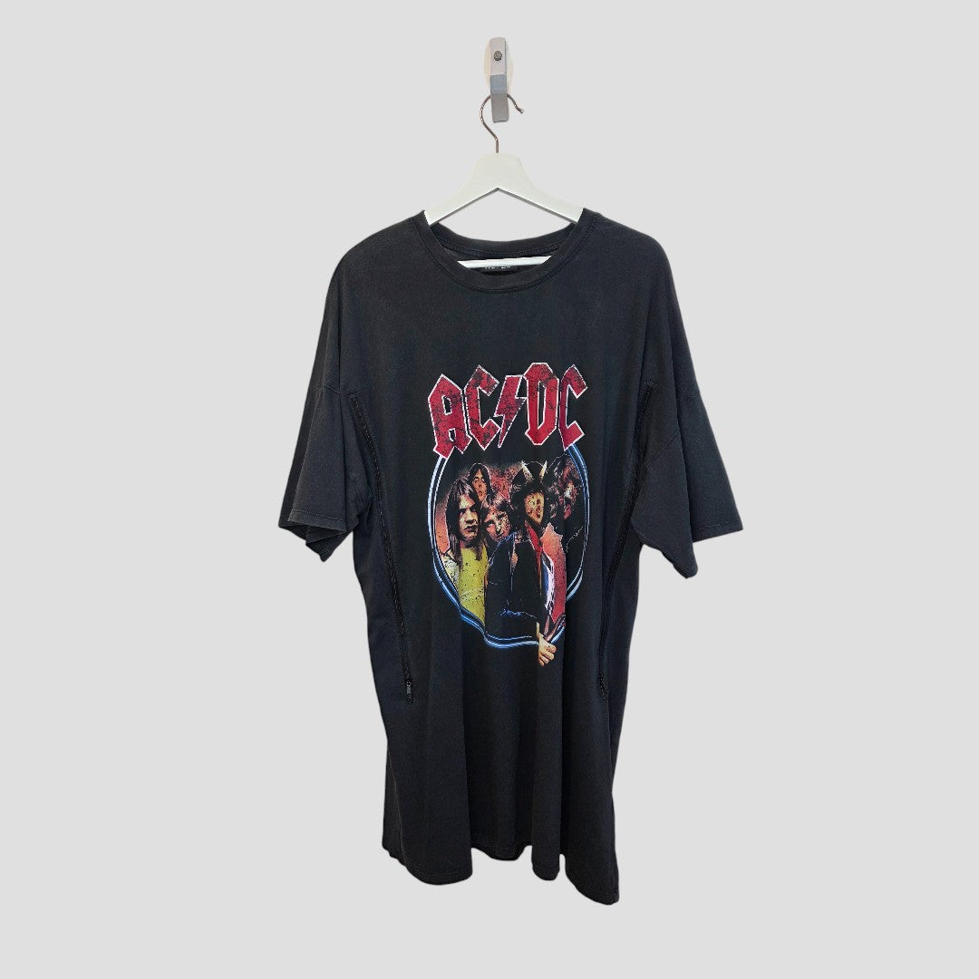 A black, upcycled Primark breastfeeding and pumping t-shirt dress (size L, UK14/16) featuring AC/DC band members' faces is displayed on a white hanger against a plain light gray background.