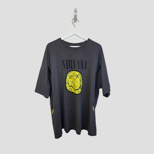 The Primark Upcycled Breastfeeding & Pumping Grey Nirvana Yellow Smile Band t-shirt (2XL UK22/24) features the band's name over a yellow smiley face—an affordable, stylish choice to pair with your favorite nursing clothes.