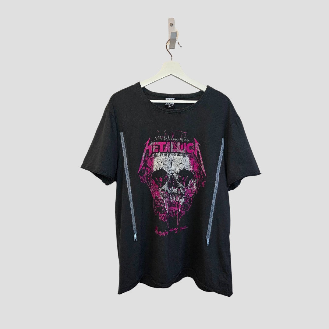 An Amplified upcycled breastfeeding & pumping Metallica band t-shirt (XXL, grey/bright pink, 100482) hangs on a white hanger against a plain light gray background. It features zipped sides and bold skull graphics for stylish nursing.
