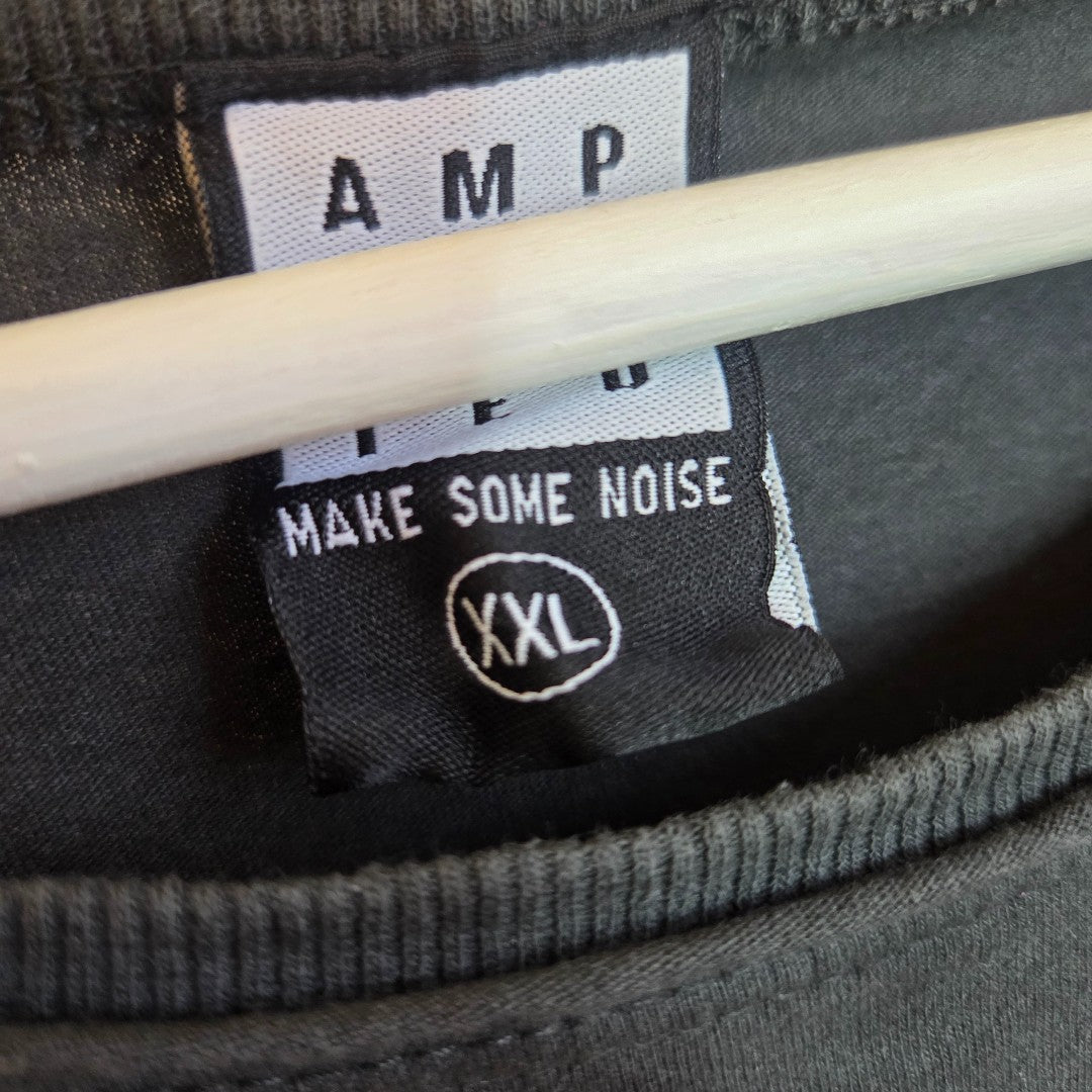 A tag on the Amplified Upcycled Breastfeeding & Pumping Grey/Bright Pink Metallica Band t-shirt XXL (100482) is partially covered, displaying bold white letters and hanging from a hanger.