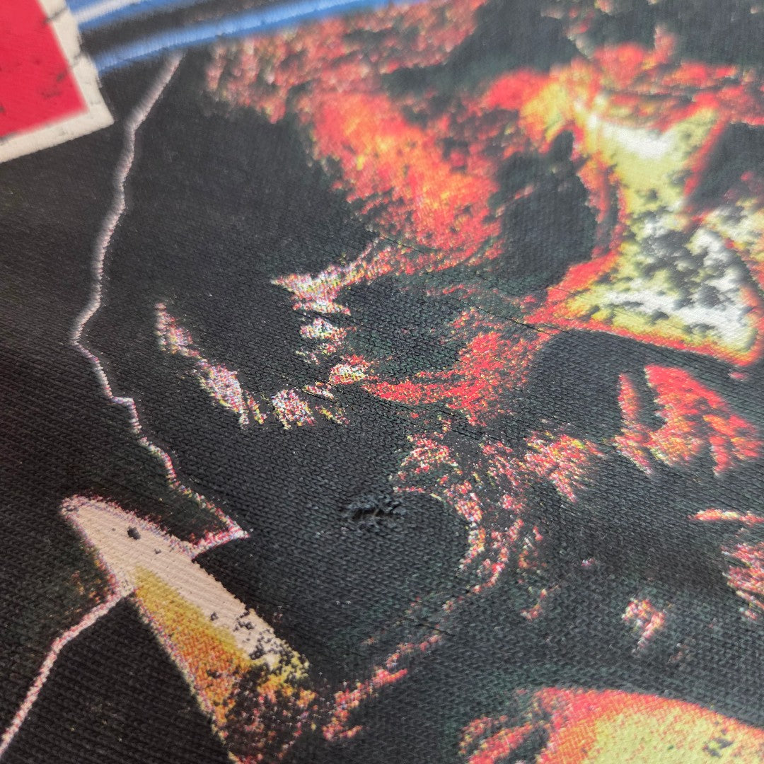 A close-up of Primark's Upcycled Breastfeeding & Pumping AC/DC Faces Band t-shirt dress (L, UK14/16) reveals a fiery-toned side profile print in red, yellow, and orange on textured fabric with a small worn spot near the center.