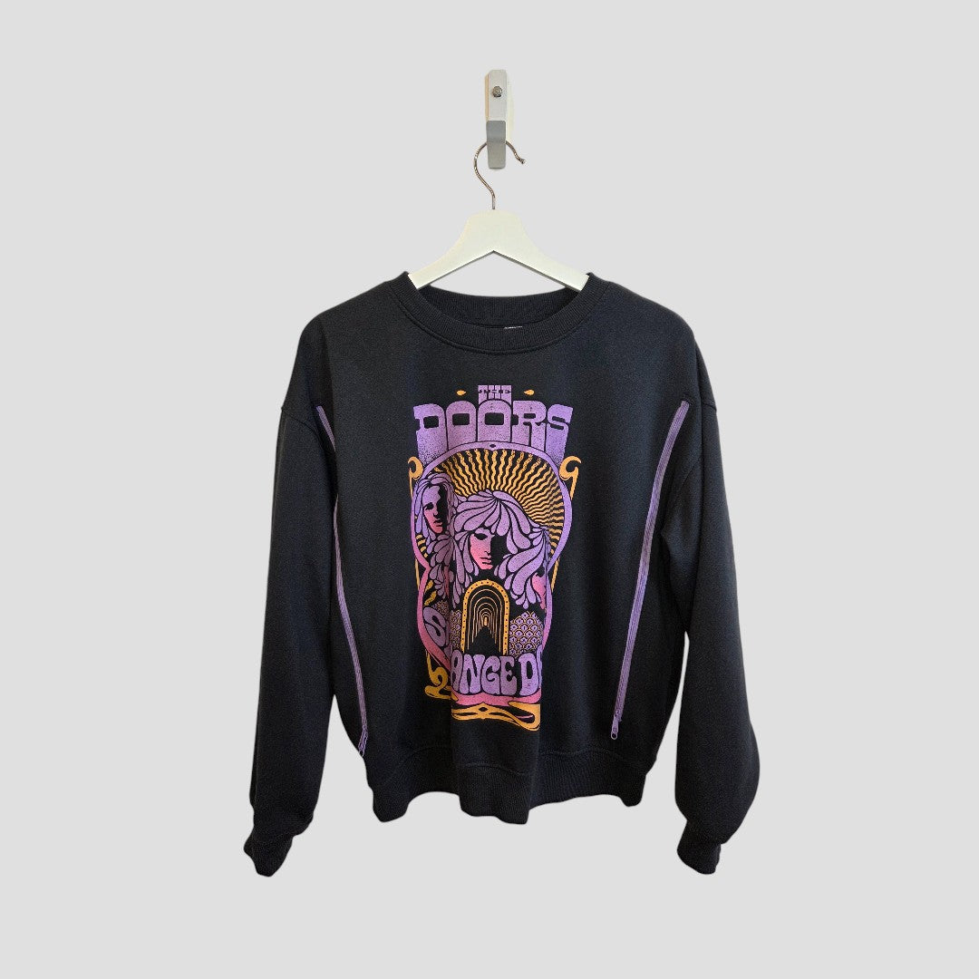 An affordable black H&M Upcycled Breastfeeding & Pumping The Doors Purple Band Sweatshirt (M) with purple and yellow psychedelic artwork, displayed on a white hanger against a plain gray background.