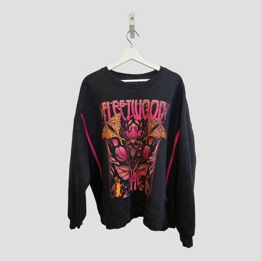 An affordable Primark black XL upcycled breastfeeding and pumping sweatshirt with colorful floral Fleetwood Mac graphic and bold "FLEETWOOD" print, displayed on a white hanger against a plain light background.
