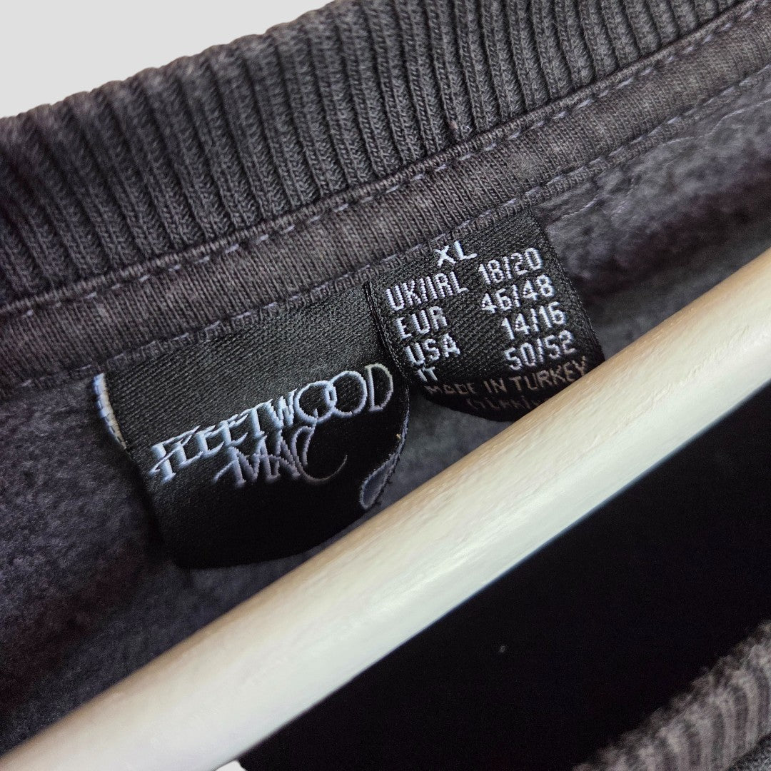 The Upcycled Breastfeeding & Pumping Floral Fleetwood Mac Band Sweatshirt XL (UK18/20) by Primark hangs on a white hanger, label showing size and care instructions. Made in Turkey, it’s an affordable choice for music-loving nursing moms.