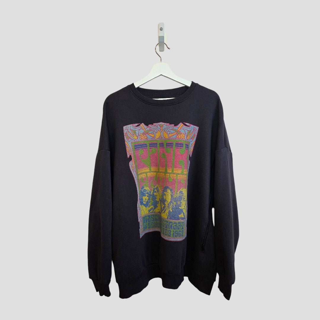 A Primark Upcycled Breastfeeding & Pumping Grey Pink Floyd Band Sweatshirt (XL, UK18/20) hangs on a white hanger against a gray background, featuring a colorful, psychedelic graphic inspired by vintage concert posters.