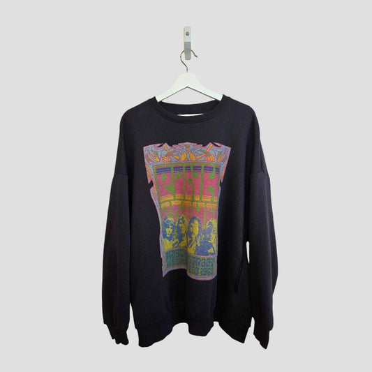 A Primark Upcycled Breastfeeding & Pumping Grey Pink Floyd Band Sweatshirt (XL, UK18/20) hangs on a white hanger against a gray background, featuring a colorful, psychedelic graphic inspired by vintage concert posters.