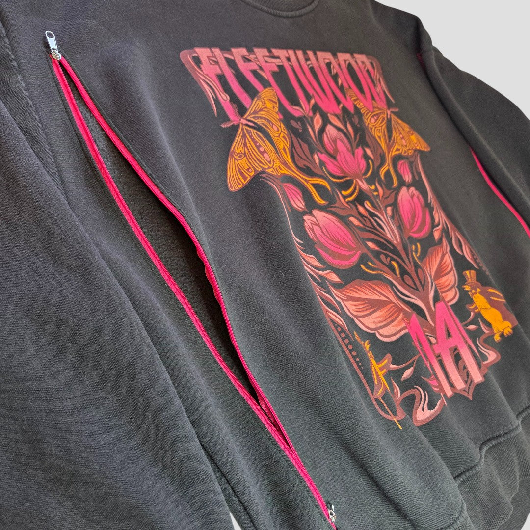 The Primark Upcycled Breastfeeding & Pumping Floral Fleetwood Mac Band Sweatshirt (XL, UK18/20) features a colorful floral and butterfly design, “Fleetwood” text, and two diagonal zippers with pink trim for easy nursing.