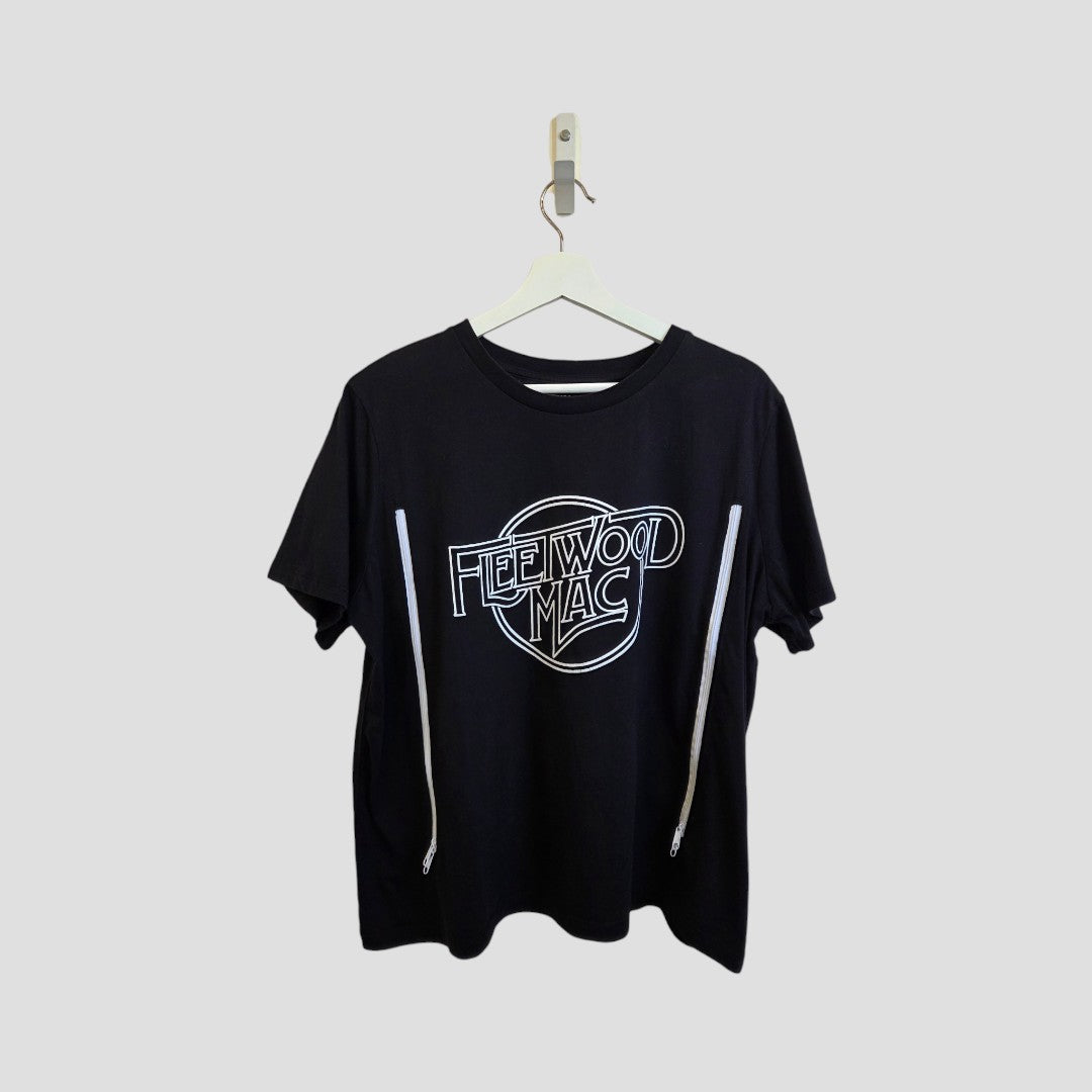 The Fleetwood Mac Upcycled Breastfeeding & Pumping White/Black Band T-shirt (L) from Fleetwood Mac is a sustainable, stylish choice for fans—shown on a white hanger against a light gray background.