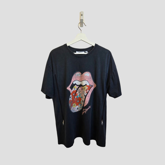 A grey Upcycled Breastfeeding & Pumping The Rolling Stones Floral Tongue Band t-shirt (L, Next) hangs on a white hanger, showcasing the iconic floral logo. Made with eco-friendly materials, it stands out against a light gray background.