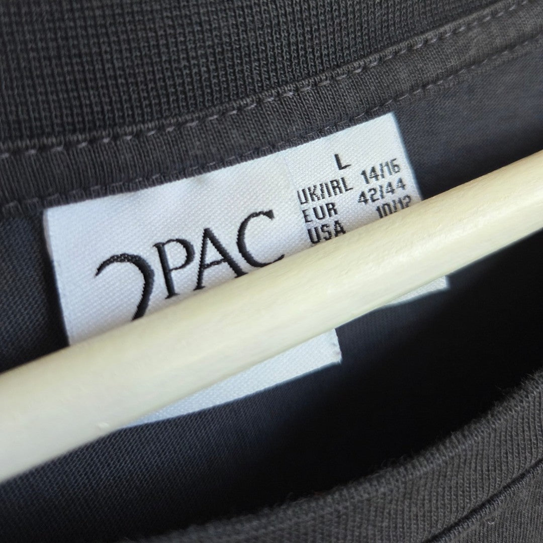 Close-up of a Primark clothing label inside a grey upcycled Tupac band nursing & pumping t-shirt (UK14/16, L), shown on a hanger—ideal for those seeking affordable, eco-friendly breastfeeding clothing options.
