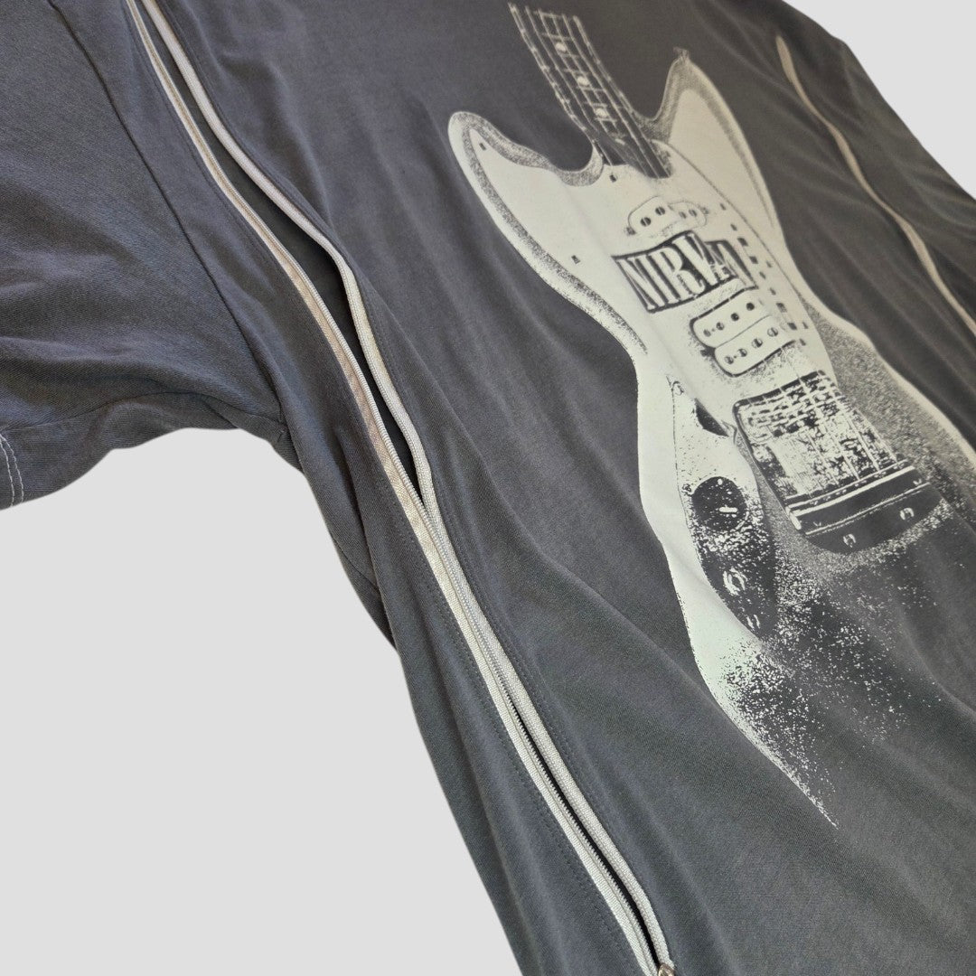 A close-up of the H&M Upcycled Breastfeeding & Pumping Grey Nirvana Guitar Band T-shirt (L, 100371), featuring a white electric guitar graphic and zipper details for easy nursing access, laid flat on a light surface.