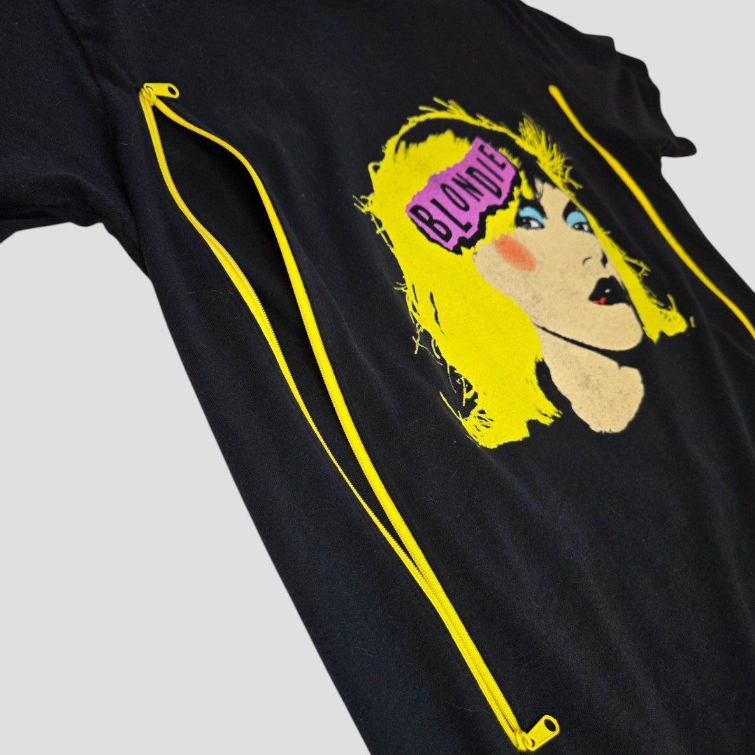 The Upcycled Breastfeeding Black Blondie Band t-shirt L by Blondie features a pink "Blondie" logo, graphic of a blonde woman’s face, and two yellow zippers for easy nursing—stylish and affordable breastfeeding clothing.