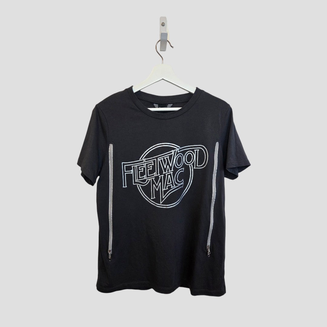 The Nutmeg Upcycled Breastfeeding & Pumping Grey/Silver Fleetwood Mac Band T-shirt (UK12, 100401) features side silver zippers for nursing and pumping. Hangs on a white hanger against a light gray background.