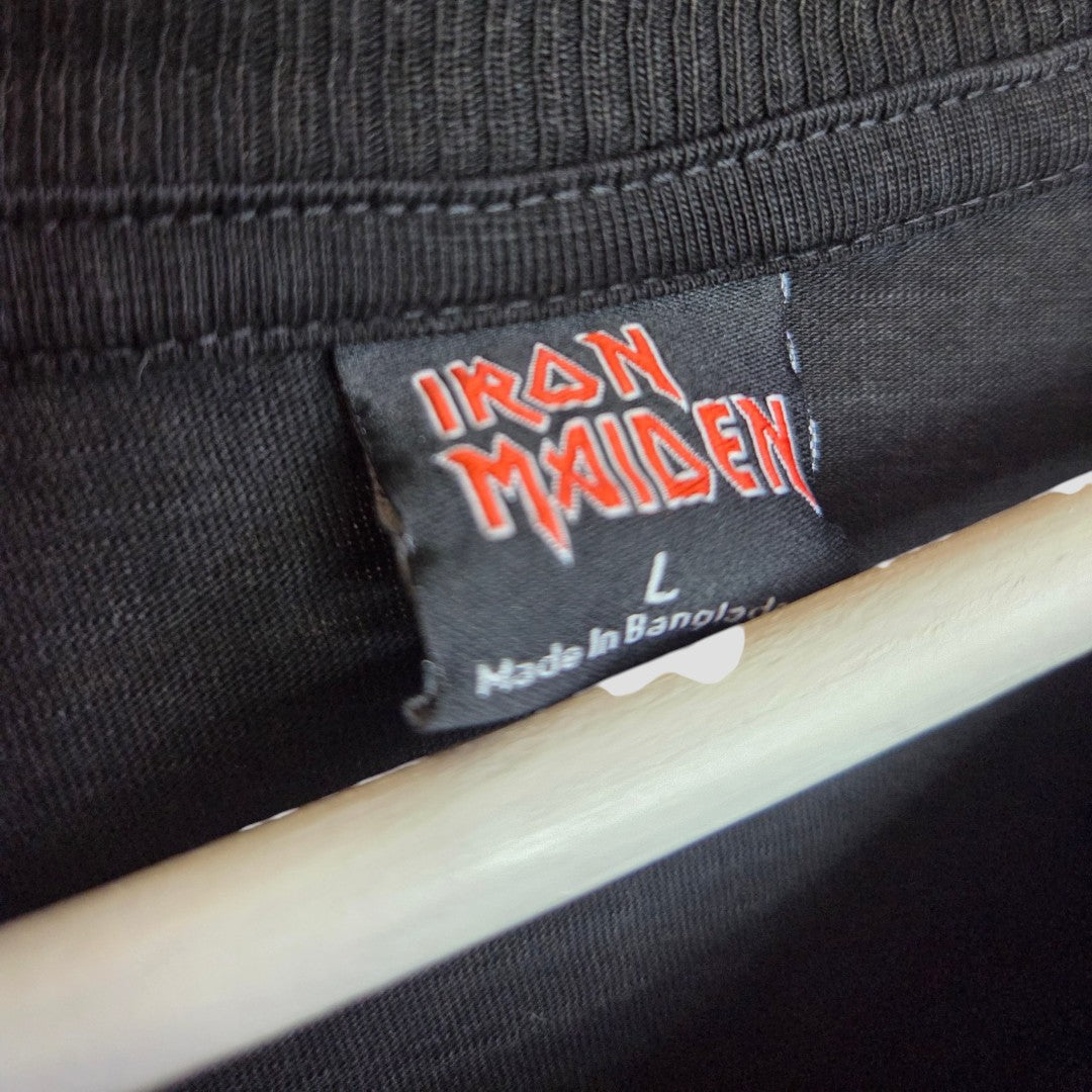 Close-up of a black Primark t-shirt collar with an Iron Maiden tag in red and white, size L, made in Bangladesh. Upcycled for affordable breastfeeding, nursing, and pumping wear.