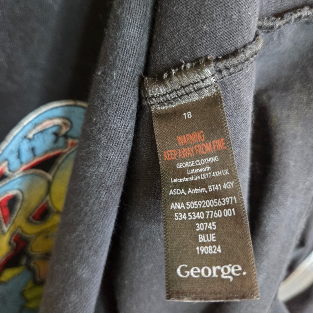 A close-up of a black George label on an upcycled breastfeeding & pumping Rolling Stones band t-shirt (UK18), showing care instructions, fire warning, and product info in white and orange text.