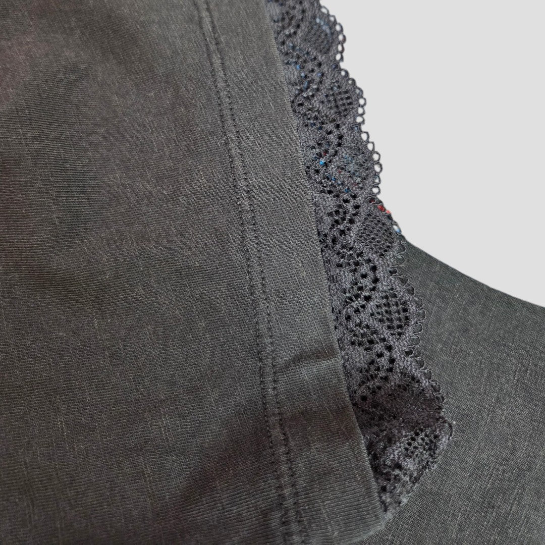 Close-up of Primark Upcycled Breastfeeding & Pumping Black Iron Maiden Killers Band t-shirt (L, 100399), featuring scalloped black lace trim and detailed stitching against a plain light background.