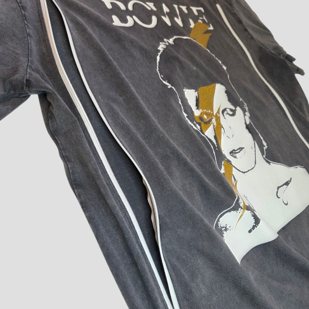 A close-up of the New Look Upcycled Breastfeeding & Pumping Grey/Gold Bowie Band t-shirt UK12, featuring an iconic black and white portrait with an orange lightning bolt and the word BOWIE partially visible at the top.