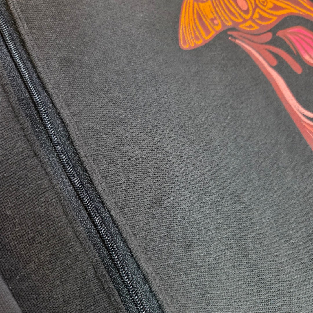 Close-up of a black Primark sweatshirt (Upcycled Breastfeeding & Pumping Floral Fleetwood Mac Band, S UK10/12) featuring a left-side zipper and vibrant orange-pink abstract design—perfect for nursing or pumping needs.