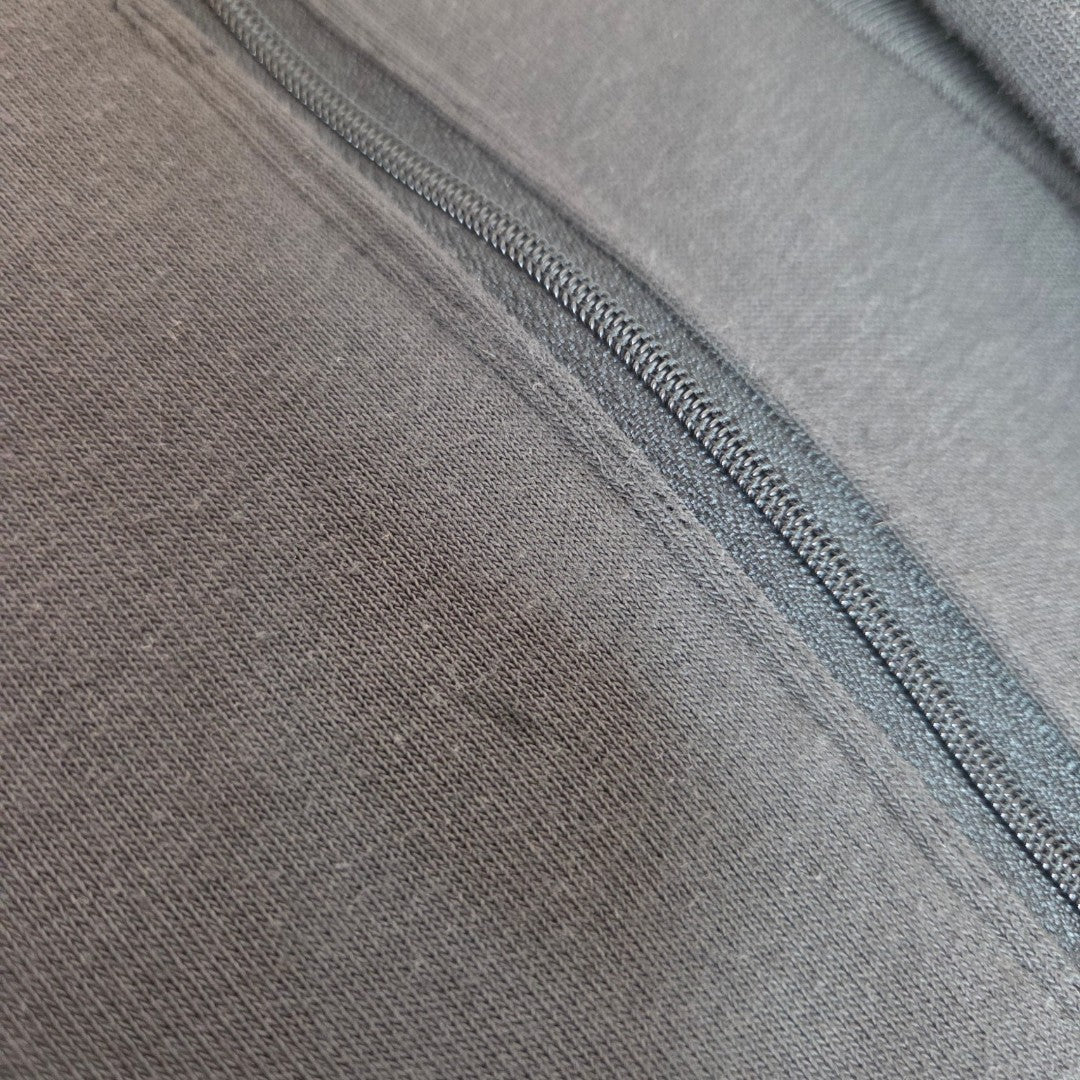 Close-up of a gray Upcycled Breastfeeding & Pumping Floral Fleetwood Mac Band Sweatshirt by Primark, size S (UK10/12), showing detailed fabric texture and diagonal zipper—perfect for nursing and pumping fans.
