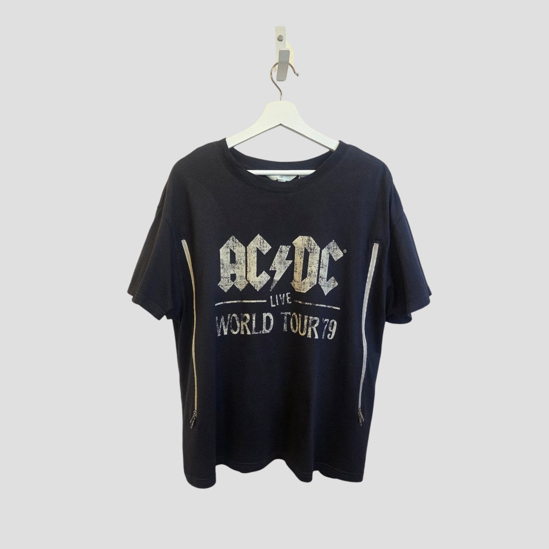An XL upcycled H&M AC/DC World Tour band T-shirt (100432) with two vertical front zippers for easy nursing and pumping, in black with white print, hangs on a white hanger against a light gray background.