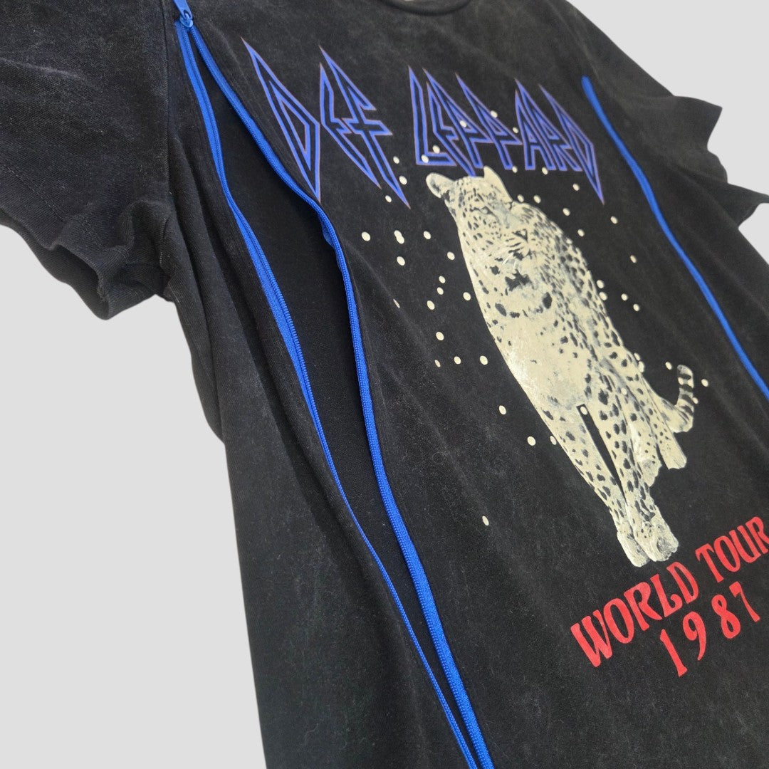 The Upcycled Breastfeeding & Pumping Black Snow Def Leppard Band t-shirt (L) by Def Leppard features blue side zippers for nursing, a white leopard graphic, blue/red text, and a vintage faded look—affordable and stylish nursing wear.