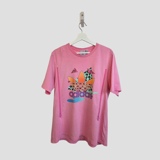 The Upcycled Breastfeeding & Pumping Pink Colourful Retro Adidas t-shirt with bow zips (L) features a vibrant, retro design and eco-friendly style, shown on a hanger against a plain light background.