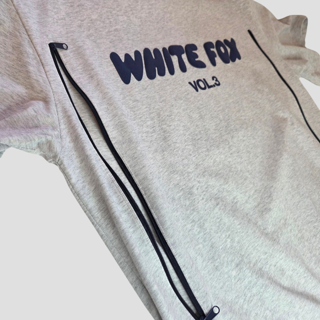 The White Fox Upcycled Breastfeeding & Pumping Grey/Blue White Fox t-shirt (L) features bold "WHITE FOX VOL.3" print, vertical side zippers for easy nursing access, and is an affordable, stylish choice for nursing moms.