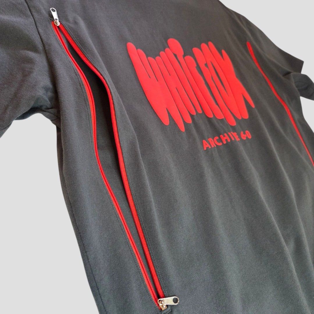 The White Fox Upcycled Breastfeeding & Pumping Grey/Red t-shirt (S/M)—features bold wavy red "WHITE FOX ARCHIVE CO" text and twin side zippers, blending nursing convenience with standout style.