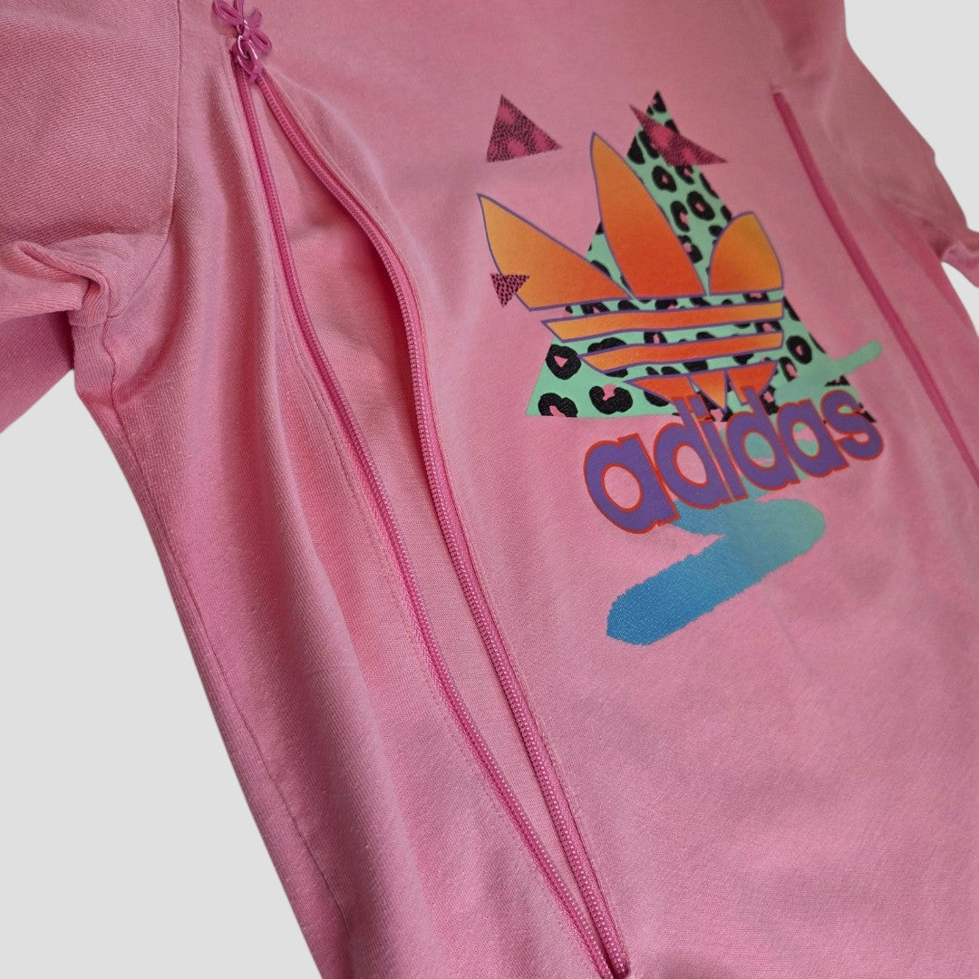 Close-up of an upcycled Adidas pink retro t-shirt with colorful patterns, bow zips for breastfeeding or pumping—stylish, practical nursing wear.