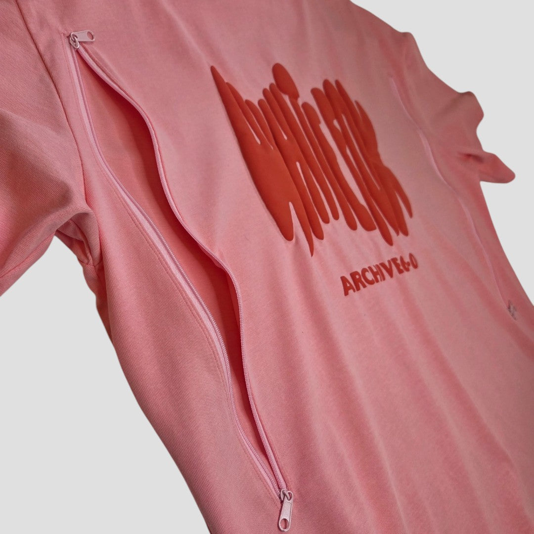 The White Fox Upcycled Breastfeeding & Pumping Pink/Red t-shirt (L) features ARCHIVE-E-O text, a red wavy graphic, and two vertical zippers from shoulders to armpits for easy nursing access and added style.