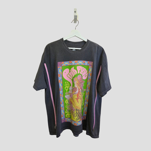 An upcycled Pink Floyd Pink/Orange Band t-shirt (M/L) for breastfeeding and pumping hangs on a white hanger, featuring vibrant psychedelic artwork—a sustainable style choice for fans seeking an eye-catching, intricate design.