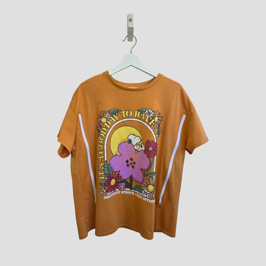 George Upcycled Breastfeeding & Pumping Orange Snoopy Flower T-shirt (UK18) on a white hanger, features colorful flowers, a smiling sun, and “Its Good in To Have Positivity Starts Within” printed on the eco-friendly fabric.