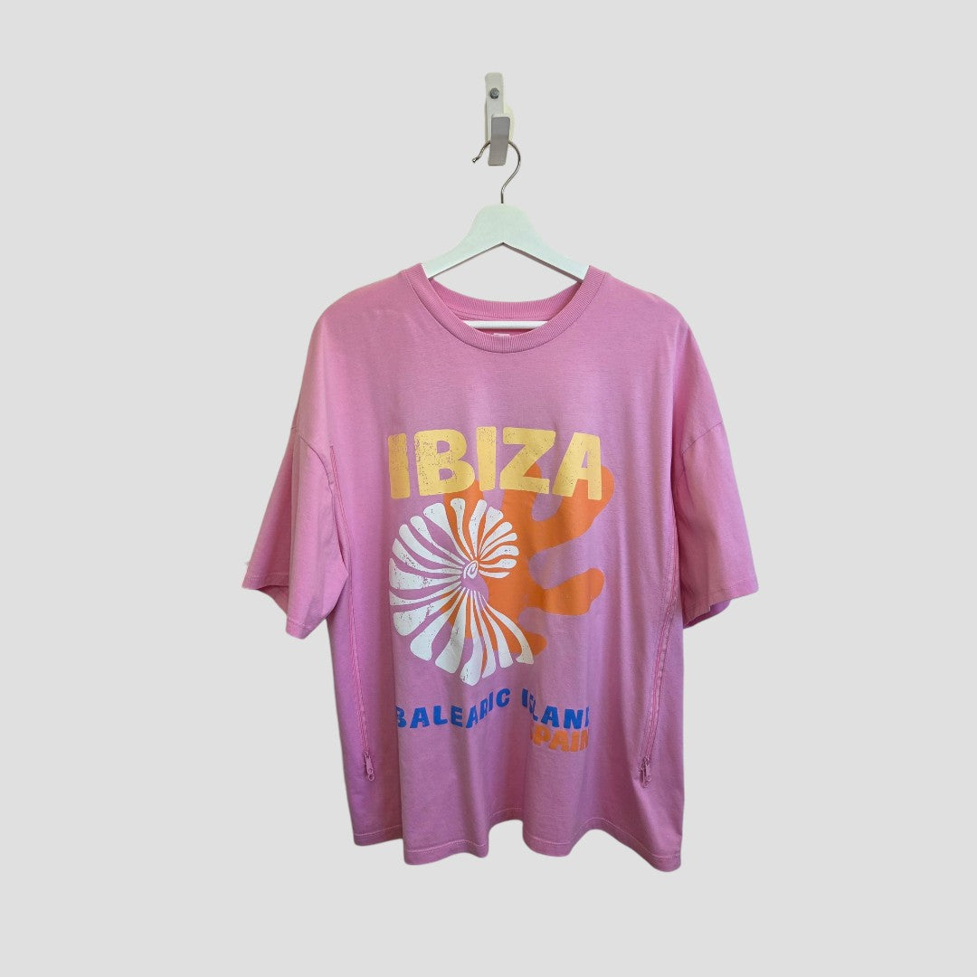 The F&F Upcycled Breastfeeding & Pumping Pink Ibiza T-shirt XL (100463) features a colorful shell and sun graphic, “IBIZA” in yellow above, and “BALEARIC ISLANDS” in blue and orange—perfect, affordable maternity wear.