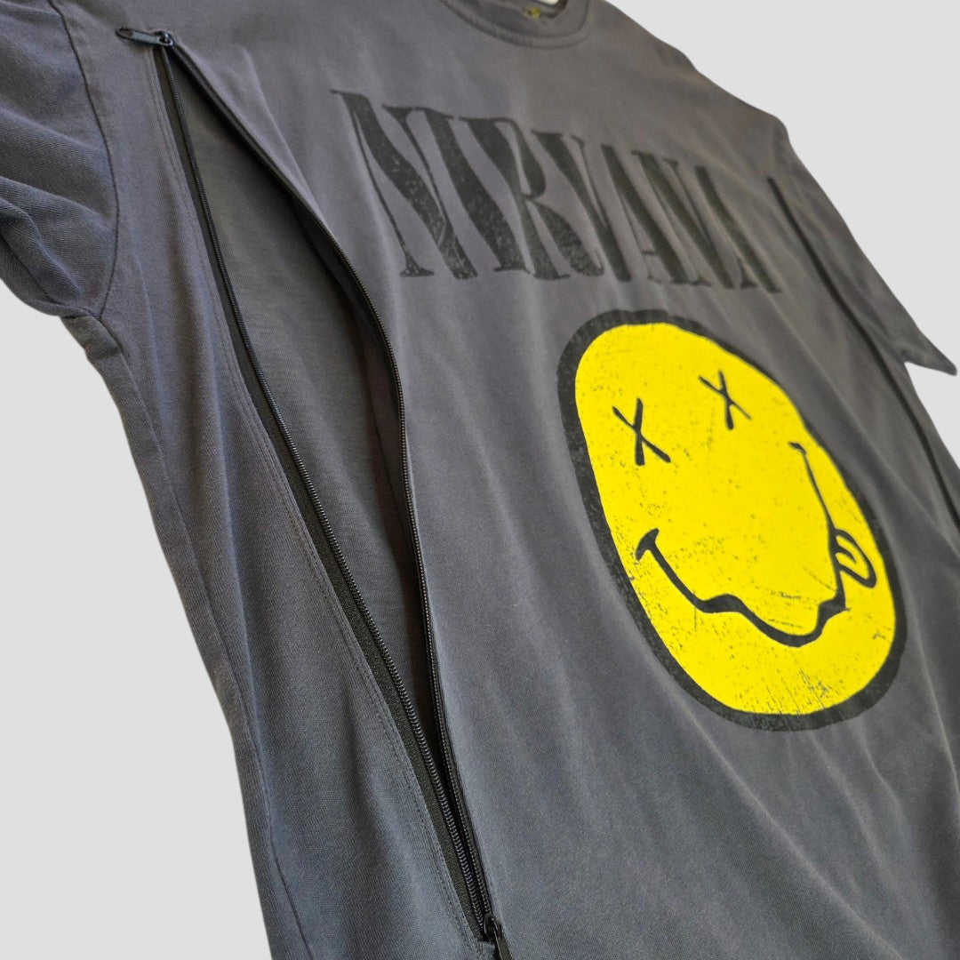 The Primark Upcycled Breastfeeding Grey Yellow Smile Nirvana Band t-shirt (L, UK14/16) features a hidden chest zipper for discreet nursing or pumping. Stylish gray with the iconic yellow smiley face logo, ideal for breastfeeding moms.