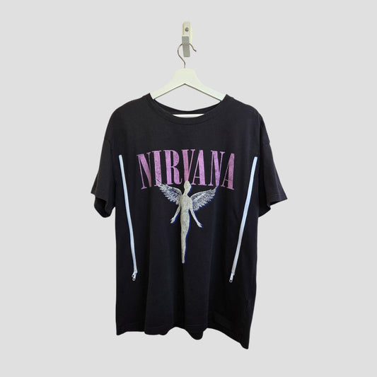 An upcycled H&M grey/pink Nirvana Angel Band breastfeeding & pumping t-shirt (L), featuring bold pink "NIRVANA" lettering above an angel graphic, displayed on a white hanger against a light gray background.