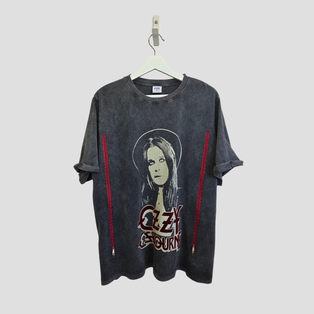 A grey Primark Upcycled Breastfeeding & Pumping Ozzy Osbourne Band T-shirt (XL) hangs on a white hanger against a plain gray background. It features Ozzy's face and his name in bold red letters, plus red accents on the sides.
