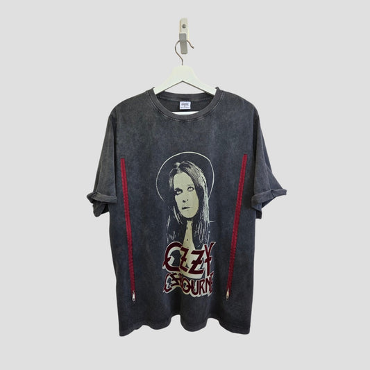 A grey Primark Upcycled Breastfeeding & Pumping Ozzy Osbourne Band T-shirt (XL) hangs on a white hanger against a plain gray background. It features Ozzy's face and his name in bold red letters, plus red accents on the sides.