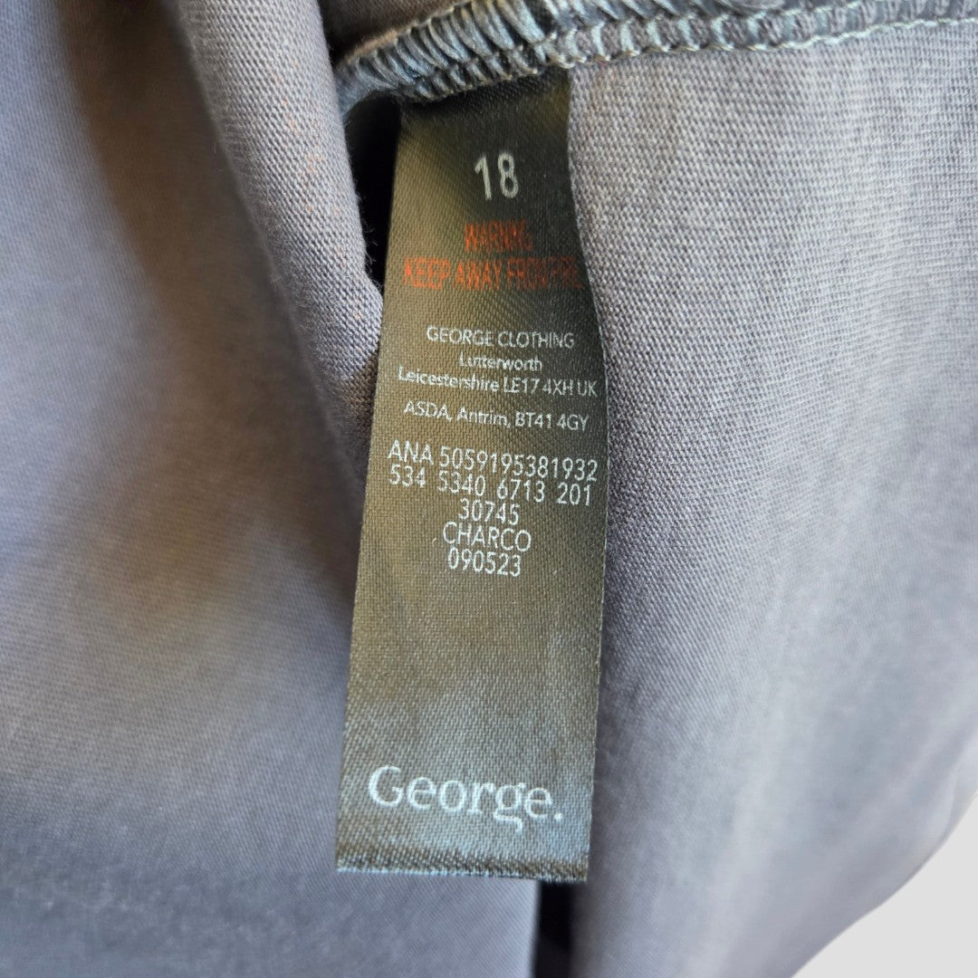 A close-up of a gray label inside a George Upcycled Breastfeeding & Pumping The Doors Band t-shirt (UK18, 100472), featuring care instructions, manufacturer info, and product codes—showcasing affordable nursing wear for new moms.