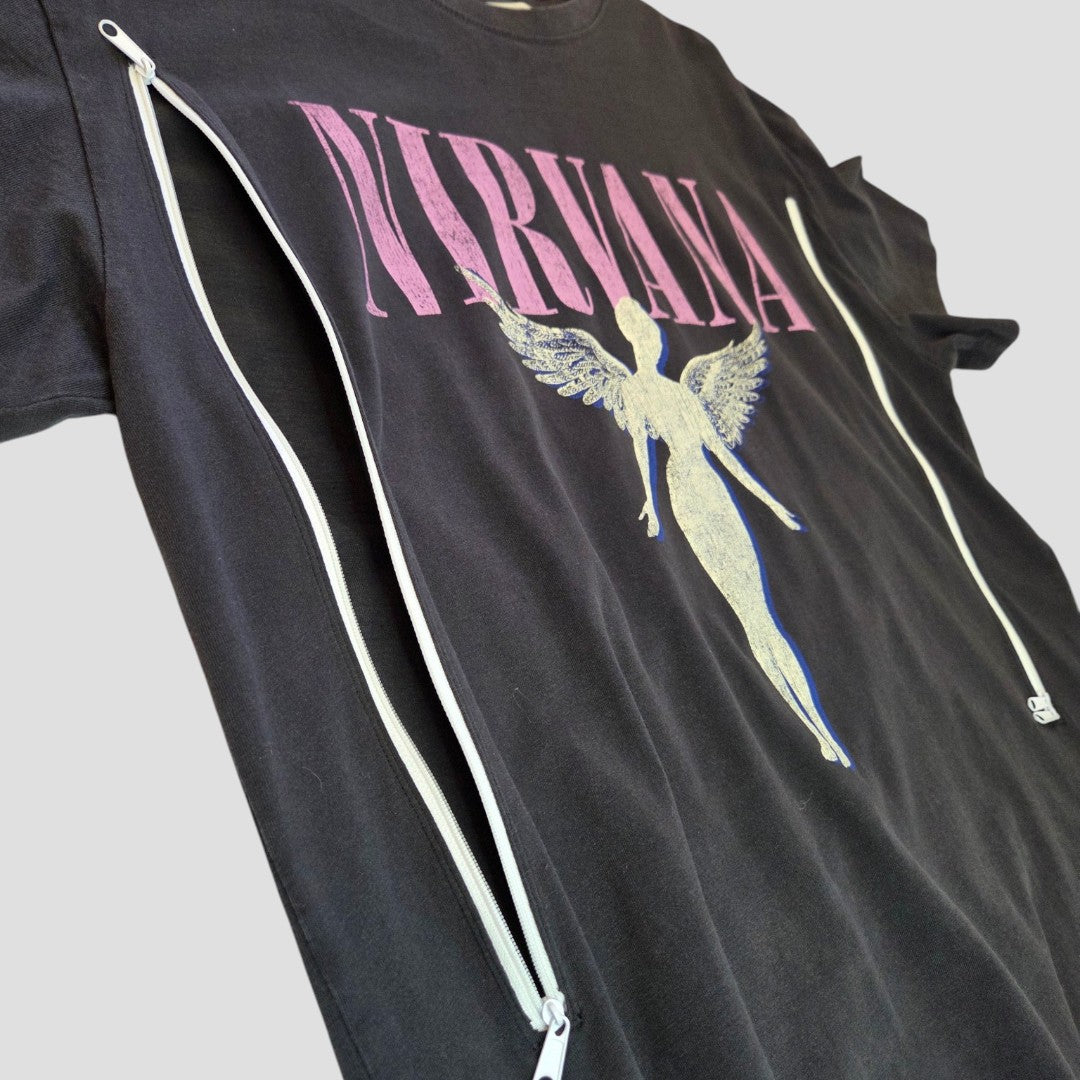 A grey and pink upcycled Nirvana Angel Band t-shirt by H&M (size L), redesigned as edgy nursing and pumping wear, features an angel graphic with large white vertical zippers on both sides against a plain light background.