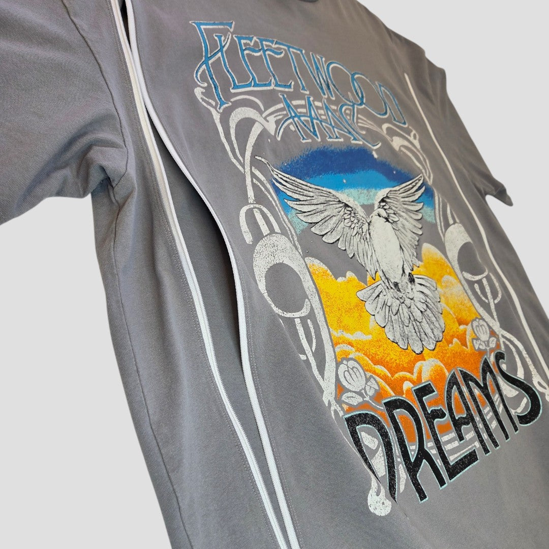 The H&M Upcycled Breastfeeding & Pumping Grey/Blue Fleetwood Mac Dreams Band t-shirt (M, 100487) features a colorful sunset graphic with a white dove and decorative designs, made from eco-friendly materials. Shown side view on plain background.