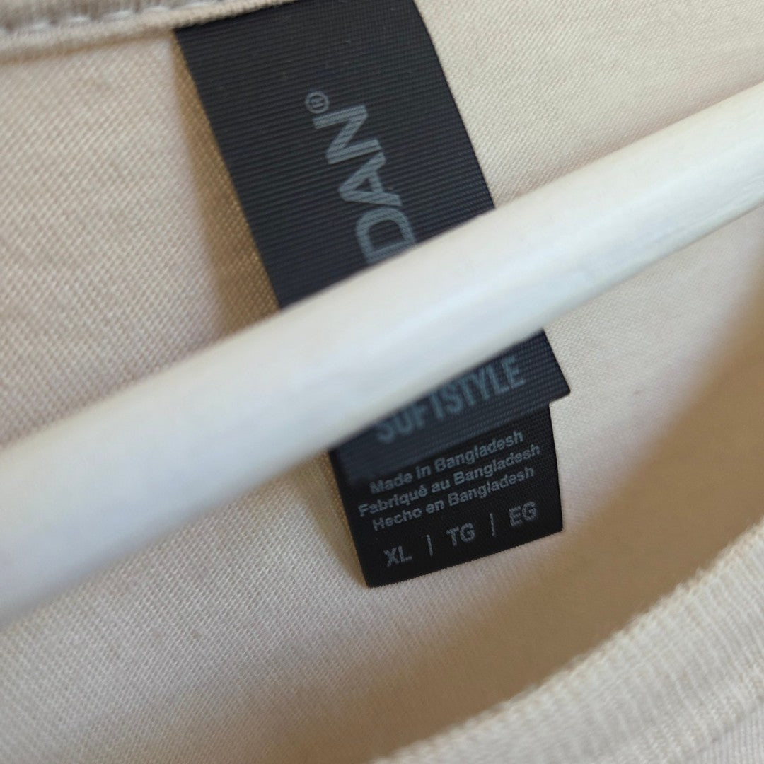Close-up of a black Gildan tag on an XL "Upcycled Breastfeeding & Pumping Bluey Chilli Mum" t-shirt, made in Bangladesh, with a white hanger partly obscuring the tag—practical and comfortable nursing wear.