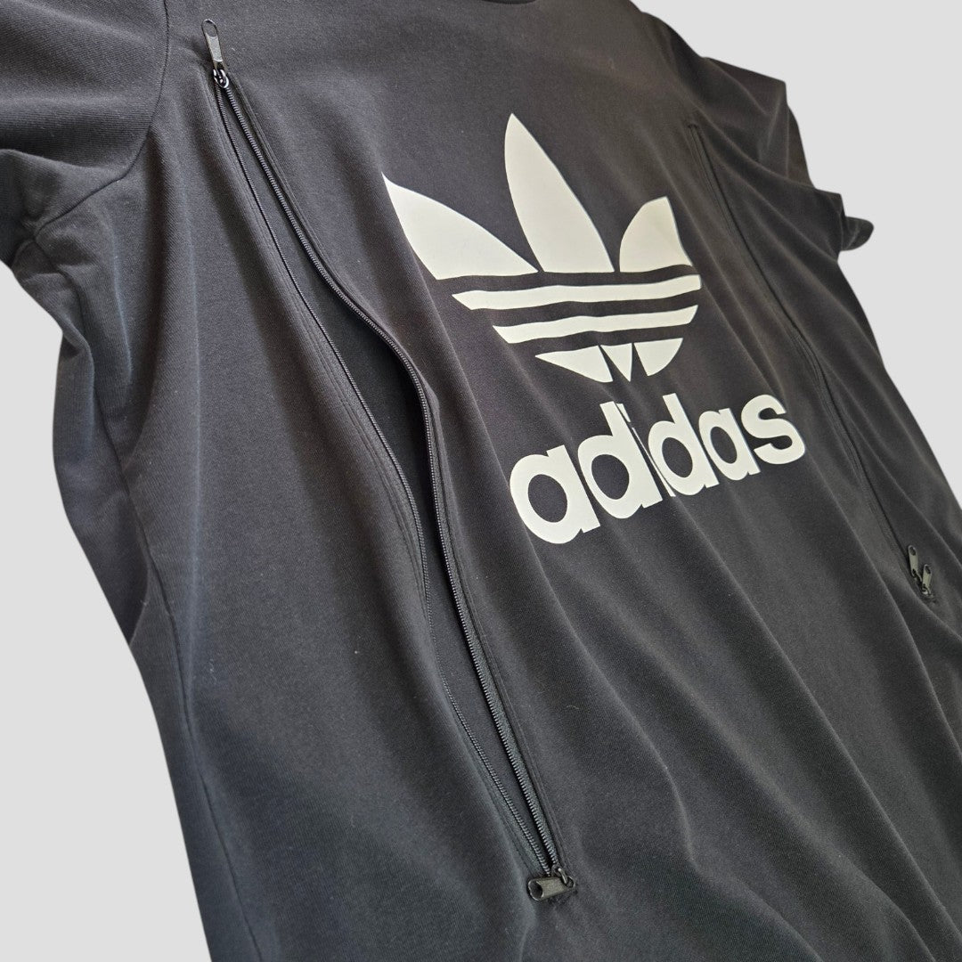 The Upcycled Breastfeeding & Pumping Black/White Logo Adidas t-shirt XXL (UK24/26) features the white trefoil logo, adidas text on the front, and two zippered chest pockets for convenient nursing.