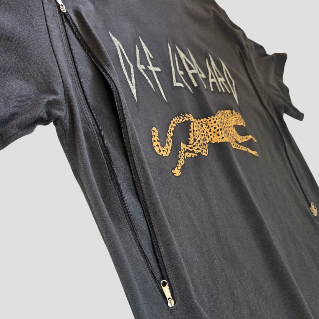 The H&M Upcycled Breastfeeding & Pumping Def Leppard Leopard Print Band T-shirt M (100525) is a black tee with Def Leppard text and a leaping cheetah graphic, featuring diagonal zippers for easy nursing access.