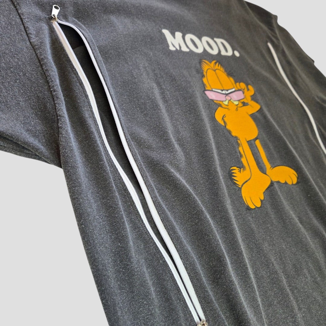 The Garfield Upcycled Breastfeeding & Pumping Mood t-shirt (L) features white vertical zippers for nursing, eco-friendly design, and a graphic of Garfield in sunglasses with “MOOD.” above him—perfect for stylish nursing moms.